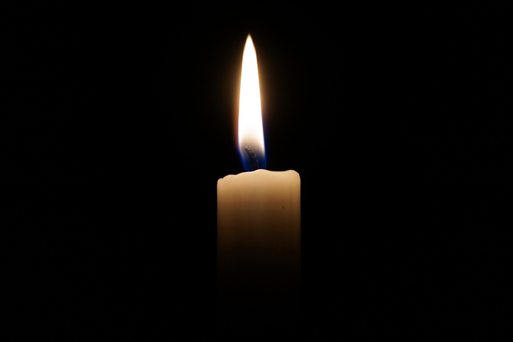 Lit Candle on a Black Background
